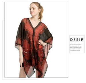 Detail of red and black paisley print chiffon cover-up with bohemian V-neck design