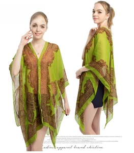 Close-up of green paisley chiffon sun shawl with batwing sleeves and V-neck detail