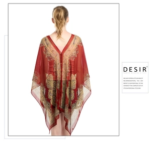 Detail of red chiffon beach cover-up with gold paisley pattern and deep V-neck back