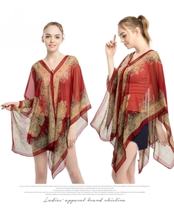 Detail of red paisley chiffon sun protection shawl with loose V-neck and tassel hemline
