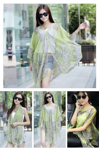 Detail of green chiffon paisley sun shawl with elegant buttons for versatile summer styling