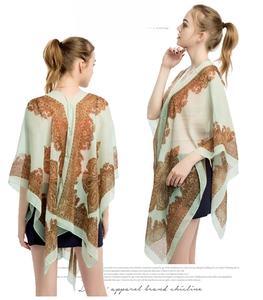 Detail of light green chiffon sun shawl with brown paisley print and flowing open front