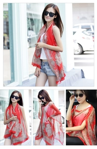 Detail of red chiffon sun protection shawl with vintage paisley print for beach wear