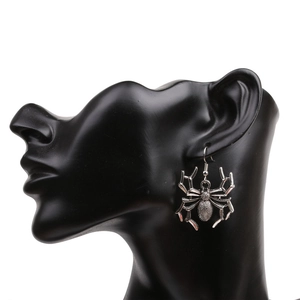 Detail of a vintage silver spider earring on a model for a gothic Halloween look