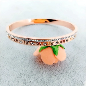 Close-up of rose gold Roman numeral bangle with inlaid zircon stones on velvet
