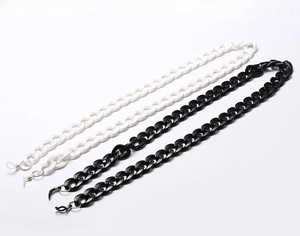 Detail view of retro thick acrylic eyewear chains in black and white with silicone loops
