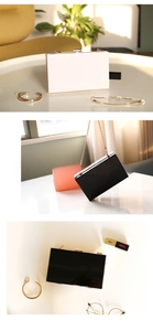 Three-color acrylic evening clutch bags in white, black and pink with gold metal chain straps
