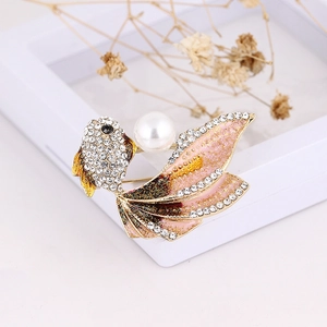 Detailed view of goldfish brooch featuring white pearls, pink enamel, and crystal inlay