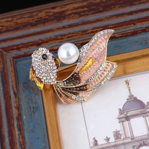 Close-up of goldfish brooch with pink gradient enamel, white pearl and crystal accents