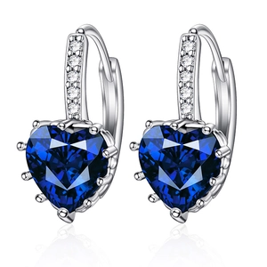 Macro detail of heart-shaped blue zircon earrings with silver plating and micro-pave setting