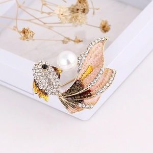 Detailed close-up of goldfish brooch with sparkling rhinestones, pearl, and pink gradient tail