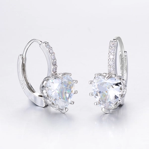 Macro shot of silver heart earrings showing S925 hallmark and sparkling cubic zirconia stones