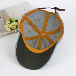 Vintage light blue denim baseball cap with brown leather strap and contrast stitching