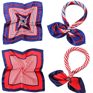 Detail of satin square scarves with red, white and blue geometric striped patterns
