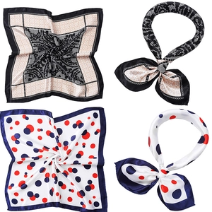 Close-up of geometric and polka dot silk scarves showing texture and pattern details