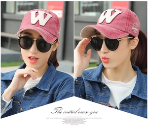 Detail showing vintage washed red cotton baseball cap with white letter W embroidery