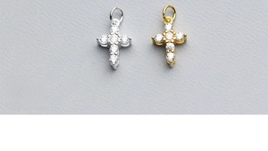 Detailed view of gold and silver cross pendants set with sparkling white cubic zirconia