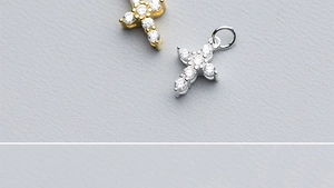 Macro shot of gold and silver S925 sterling silver cross pendants with cubic zirconia