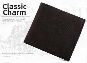 Close-up of vintage brown men's bi-fold wallet showing detailed pebble grain texture