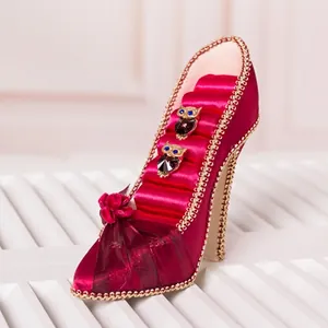 Creative red high heel jewelry display stand with satin finish and floral decor