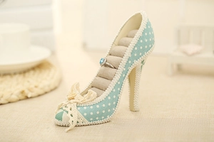 Detail of high heel ring display stand with polka dot fabric and lace trim decoration