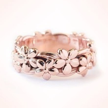 Close-up of rose gold cherry blossom ring showing intricate petal details and elegant finish