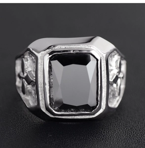 Detail showing mens silver signet ring with black rectangular zircon stone and cross carving