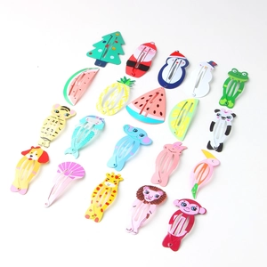 Close-up of various colorful cartoon painted metal hair clips for kids on white background