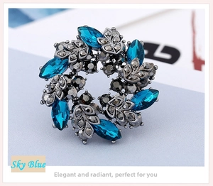 Macro shot of sky blue crystal wreath brooch in vintage silver setting with marquise cut stones