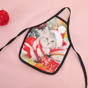 Detail of red festive pet apron with cute Christmas cat print and tie-on design