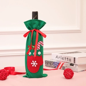 Christmas felt wine bottle cover with red ribbon, snowflake, and mittens decorations