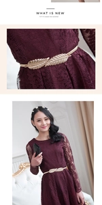 Detail of a golden leaf metal belt paired with a wine red lace long sleeve dress