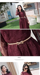 Close-up of golden leaf elastic belt on wine red lace long sleeve dress in garden