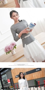 Detail of silver leaf metal elastic belt paired with a grey knit top and chiffon skirt