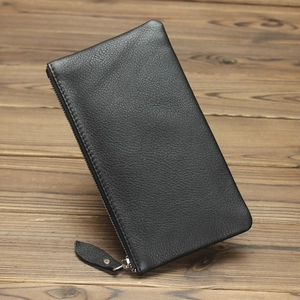 Close-up of black lychee texture leather wallet with silver metal zipper detail