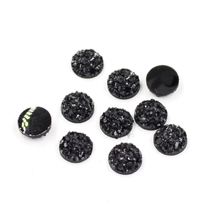 Macro detail of 8mm black starry resin flatback rhinestones for DIY jewelry crafts