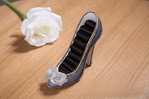 Detailed view of high heel ring display stand with blue glitter finish and velvet slots