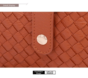 Close-up of woven brown leather shoulder bag featuring a round metal snap button closure