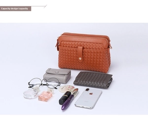 Orange hand-woven shoulder bag showing interior capacity with daily essentials
