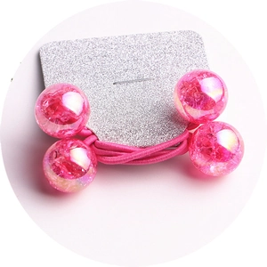 Detailed view of pink elastic hair tie with four translucent cracked rainbow beads