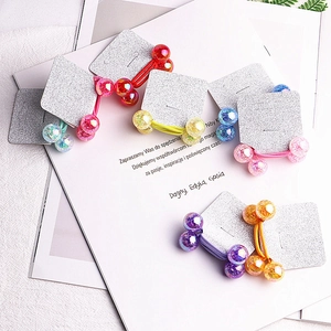 Set of 7 colorful glitter bead hair ties on a metallic display card for kids