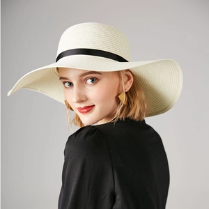 Classic wide brim straw sun hat for women featuring a black ribbon bow for summer beach travel