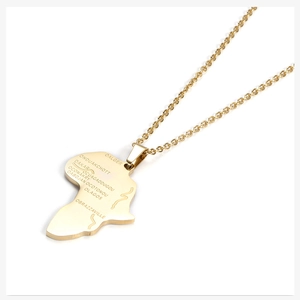 Detailed macro view of gold Africa map pendant with engraved city names and polished finish