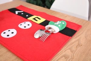 Close-up of red felt Christmas placemat with a green snowflake glove cutlery pocket