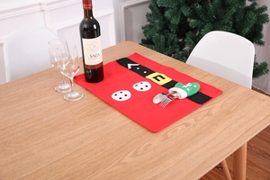 Close-up of a festive red Christmas placemat with Santa belt design and cutlery pocket