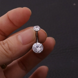 Macro shot of 316L stainless steel belly ring with double clear zircon crystals