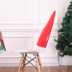 Side view of an extended red and white Santa hat chair cover on a white Eames style chair