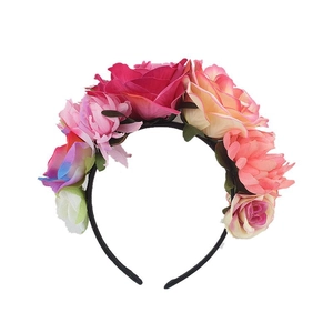 Close-up of artificial pink and white roses on a black headband for bohemian style