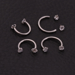 Macro view of 16g stainless steel horseshoe rings with clear cubic zirconia stones