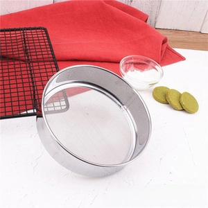 Close-up of a 304 stainless steel flour sifter on marble surface with baking ingredients